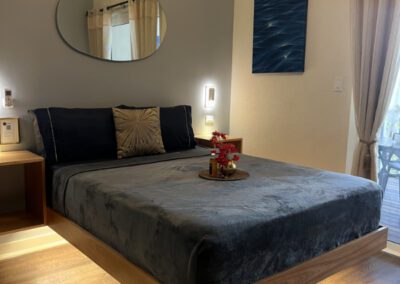 Floating queen bed with complimentary rum punch and mirror above.