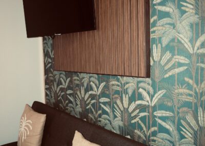 Futon with wall-mounted TV above.