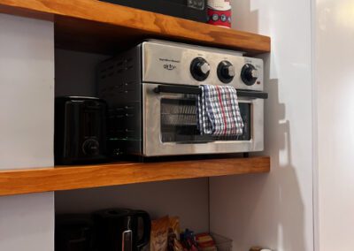 Kitchenette with microwave, toaster oven, sink, kettle, toaster and complimentary tean and coffee.