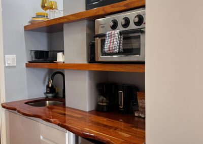 Kitchenette with microwave, toaster oven, sink, crockery, mini-fridge and complimentary tean and coffee.