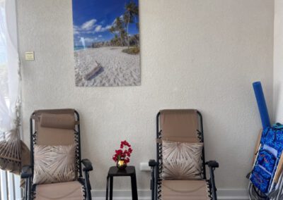 Two fully reclining chairs are situated in the balcony.