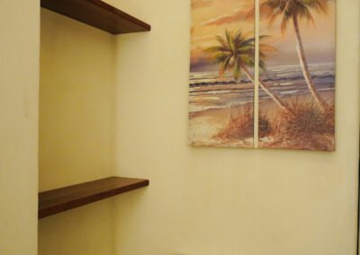 Local seascape artwork above WC and bathroom shelving.