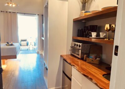 Kitchenette with microwave, toaster oven, sink, crockery, kettle, coffee maker, toaster, mini-fridge and complimentary tean and coffee.