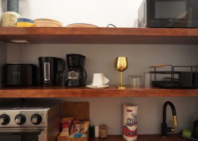 Kitchenette with microwave, toaster oven, sink, crockery, kettle, coffee maker, toaster and complimentary tean and coffee.