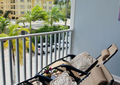 Verandah showing neighbourhood view with 2 fully reclining chair loungers.