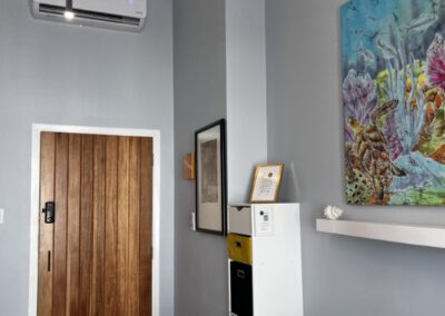 Edge of sofa, convenient drawer access and exit door to apartment.