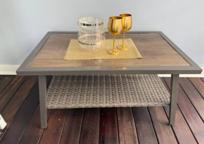 Verandah coffee table with golden wine goblets.