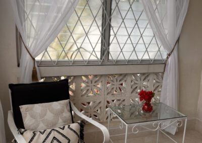 Single wrought iron chair in internal front patio.