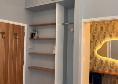 Escape bedroom shelves showing safe and clothes steamer.