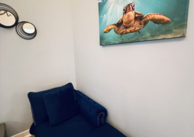 Futon situated below a seascape including a giant turtle.